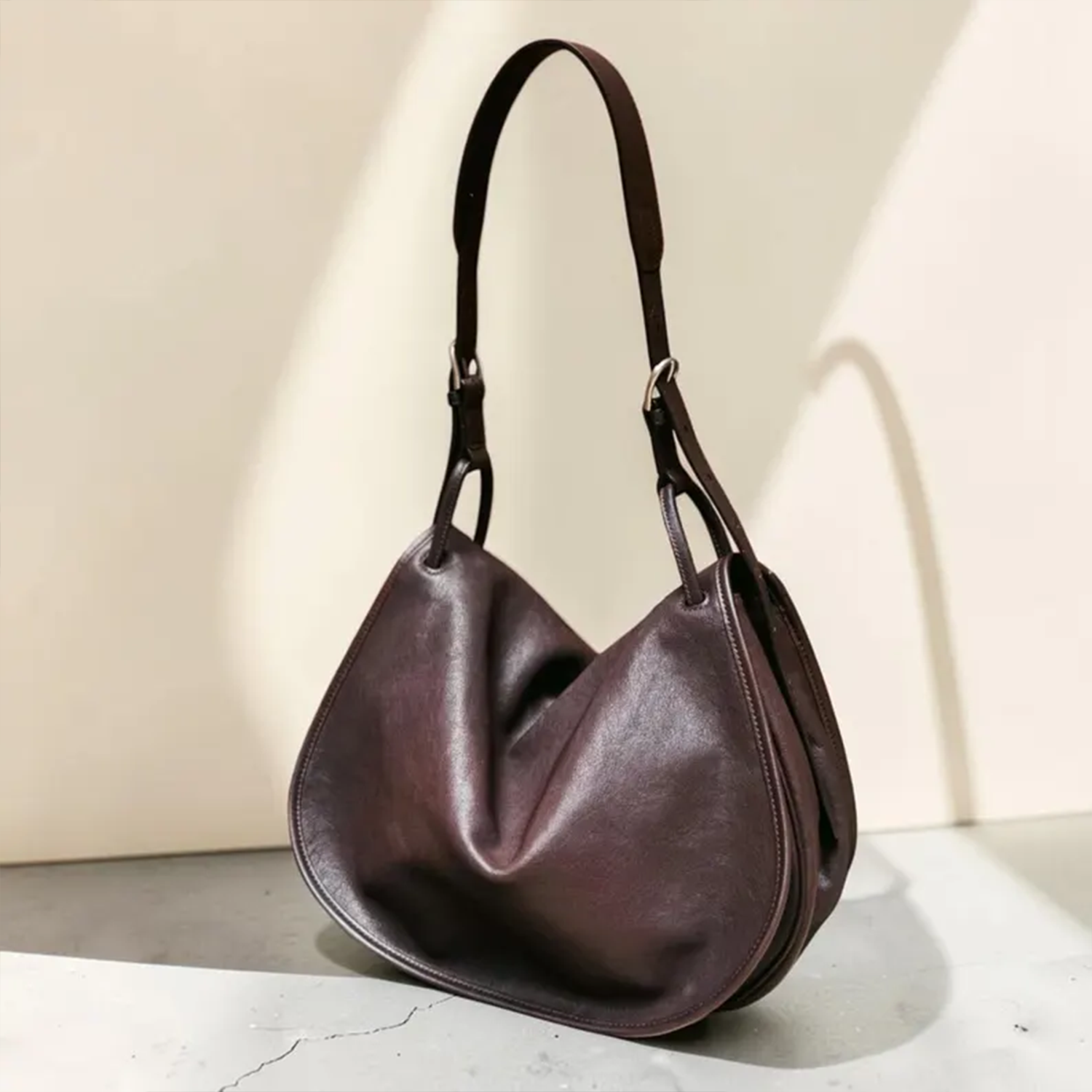 Deep Coffee Brown Soft Draped Saddle Shoulder Pouch With Adjustable Single Hanging Strand, Curved Edge Stitch Detailing And Spacious Unfastened Top Cavity