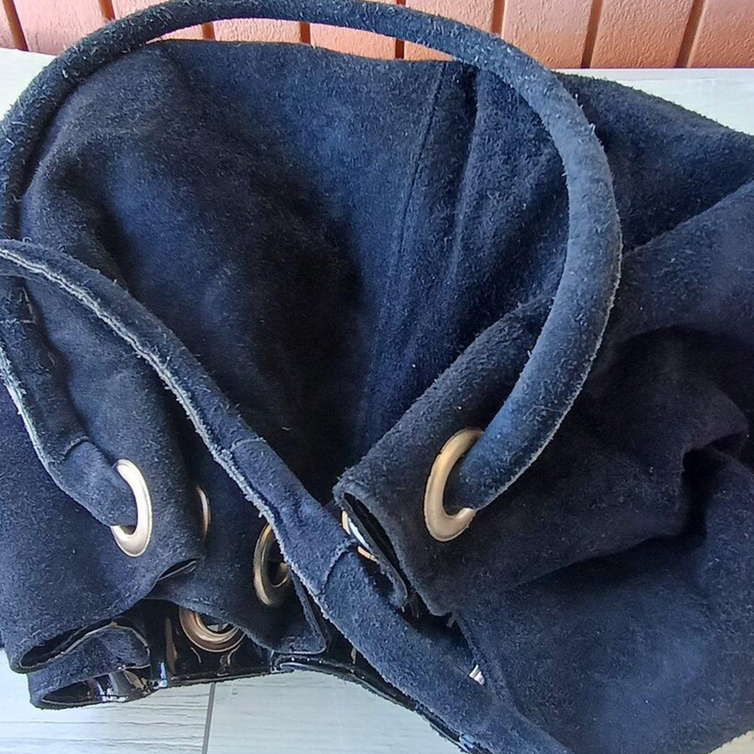 Deep Navy Plush Fuzzy Drawstring Bucket Pouch With Metallic Eyelet Rim Hardware, Wide Integrated Shoulder Strap And Relaxed Draped Silhouette