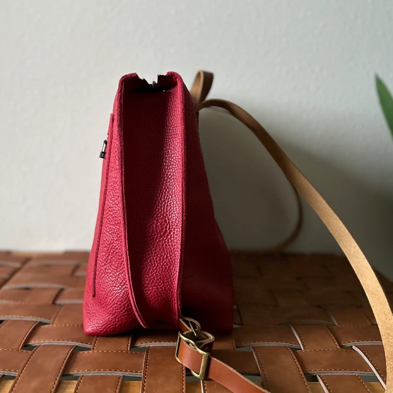 Scarlet Red Pebbled Trapezoid Rucksack With Tan Contrast Straps, Top Rear Hand Loop, Exterior Zip Slip Pocket And Multi-Slot Interior Dividers Backpack