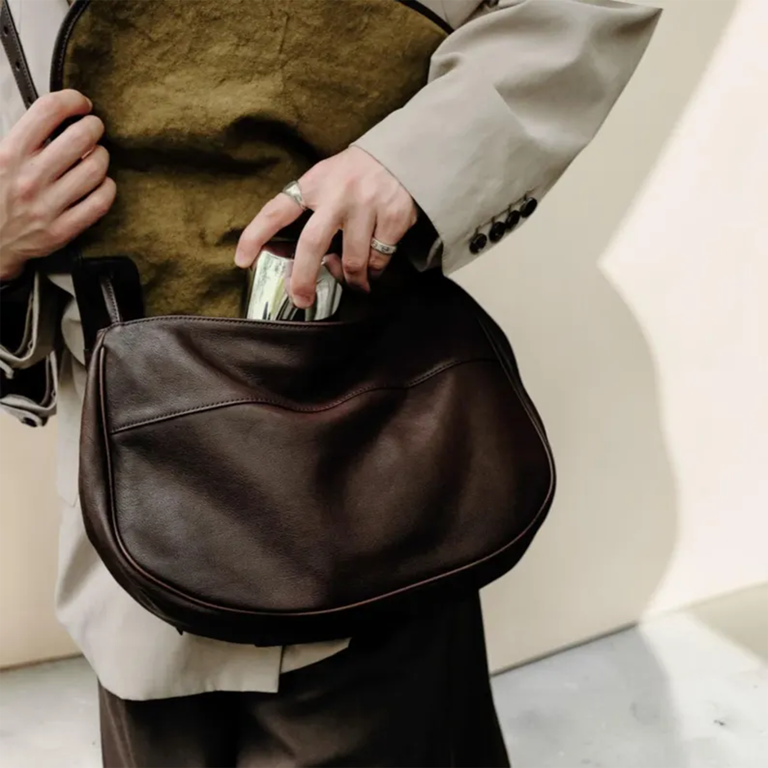 Deep Coffee Brown Soft Draped Saddle Shoulder Pouch With Adjustable Single Hanging Strand, Curved Edge Stitch Detailing And Spacious Unfastened Top Cavity