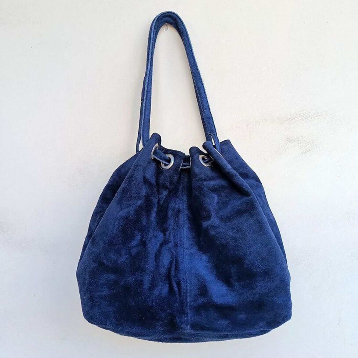 Deep Navy Plush Fuzzy Drawstring Bucket Pouch With Metallic Eyelet Rim Hardware, Wide Integrated Shoulder Strap And Relaxed Draped Silhouette